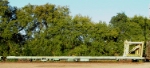 Kershaw equipment unloader rides end of a 20+ flatcar work train.